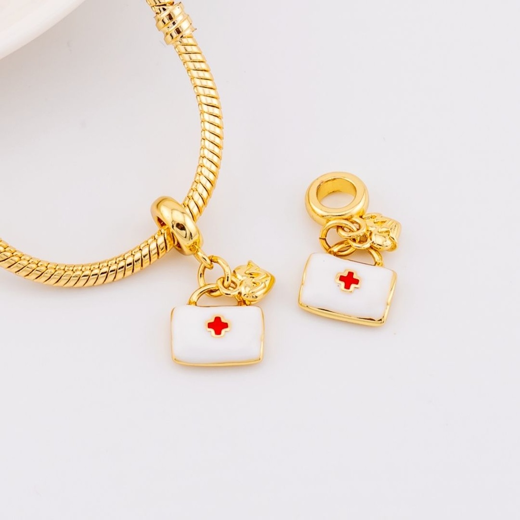 Dije charm de botiqiuin hospital esmaltado  baño de 18k