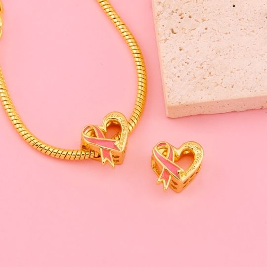 Charm corazon lazo rosado cancer de mama baño 18k
