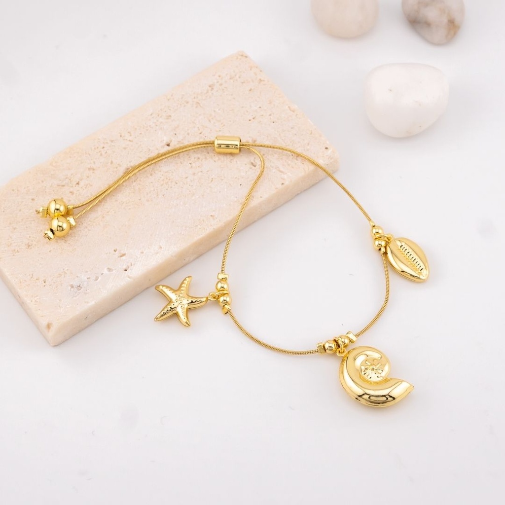 Pulsera ajustable con dijes marinos estrella, caracol y concha de mar  baño 18k