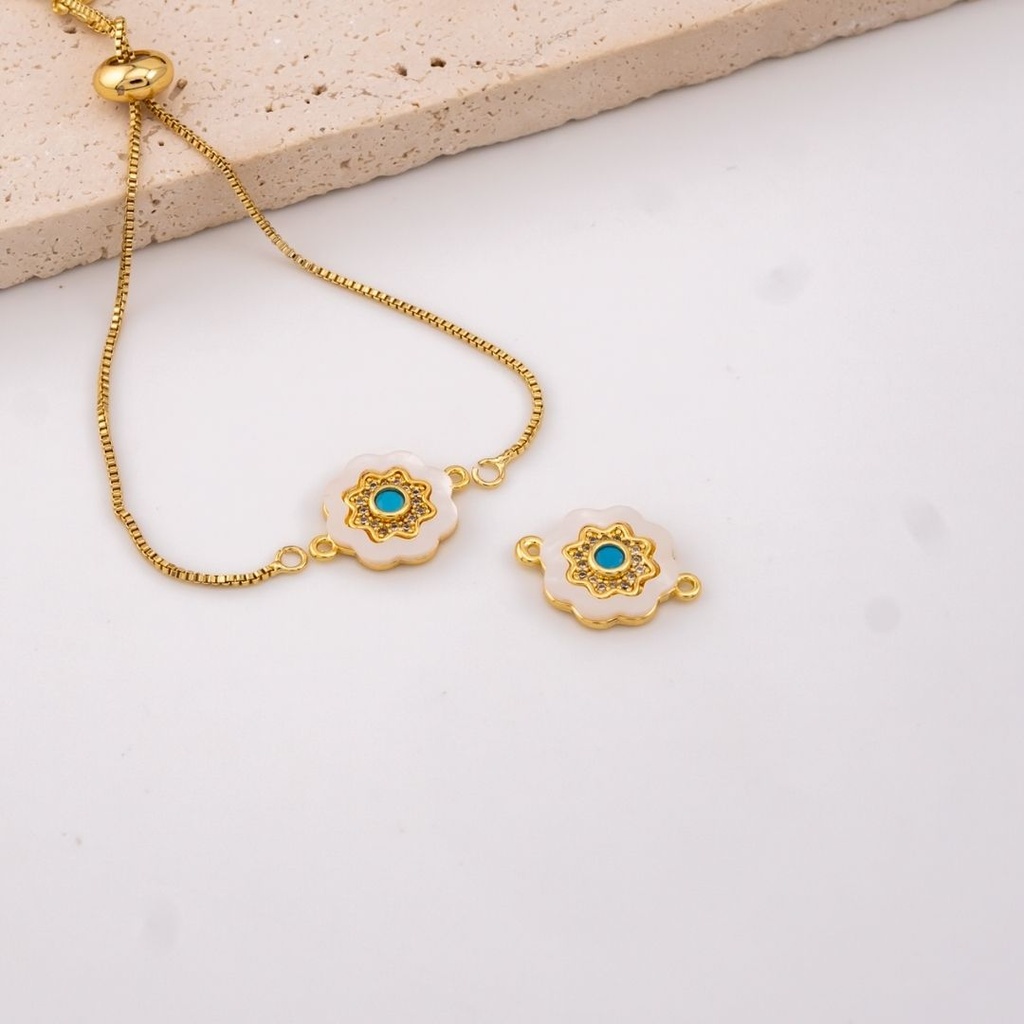 Enlace flor madre perla centro turqueza baño 18k