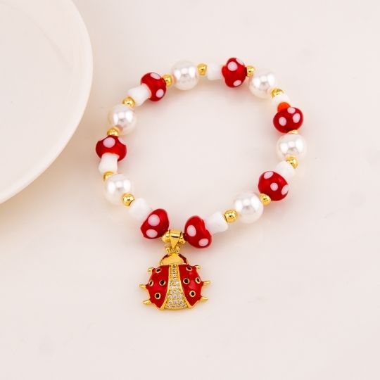 Pulsera elastica de hongos con colgante de mariquita baño 18k