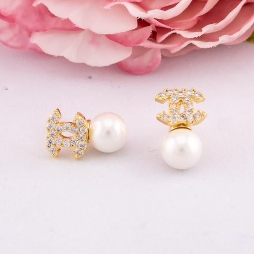Aretes stud de marca con zirconias y perlas baño 18k