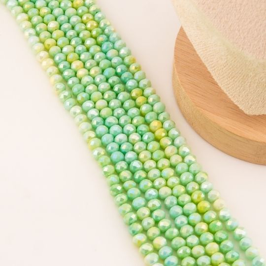 Cristal jade de 6mm facetado color verde menta con recubrimiento Aura/AB