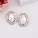 Aretes chunky ovalados con perla shell baño 18k plat