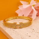 Brazalete de marca con zirconias baño 18k