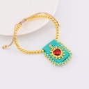 Pulsera ajustable con escapulario tejido a mano con  baño 18k