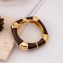 Pulsera café con dorado baño 18k