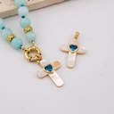 Dije cruz madre perla corazon azul baño 18k