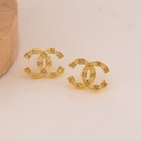 Aretes stud de marca con zirconias baño 18k