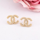 Aretes stud de marca con perlas y zirconias baño 18k