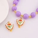 Dije de ceramica vitrificado en forma de corazon con diseño de flor baño 18k
