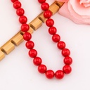 Collar bola chicle rojo en concha nacar baño 18k
