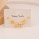 Set de aretes de flor con zirconias baño 18k